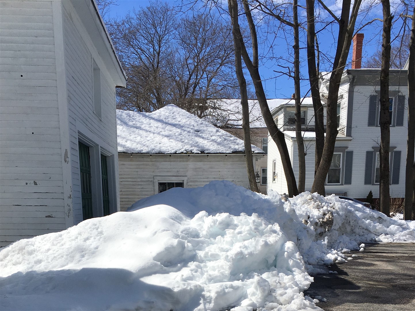 Large snowbank in front of garage door
