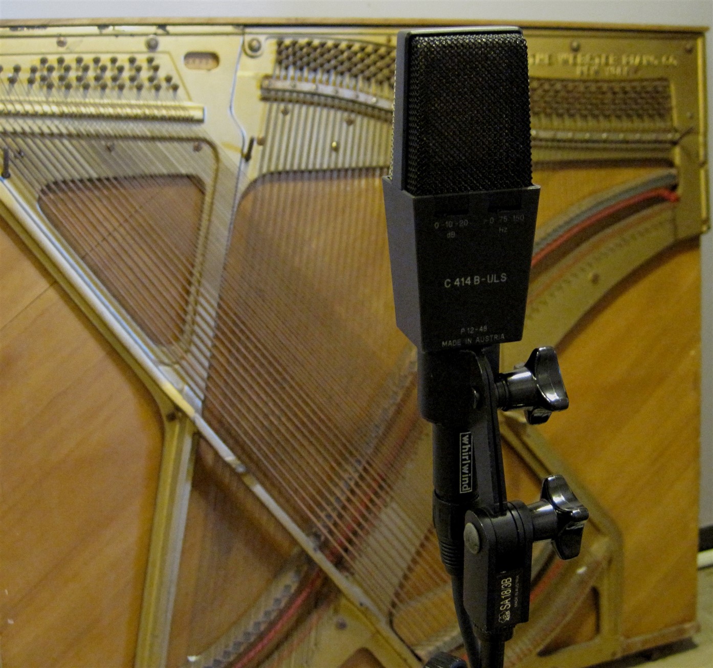 The strings of piano with a microphone in front